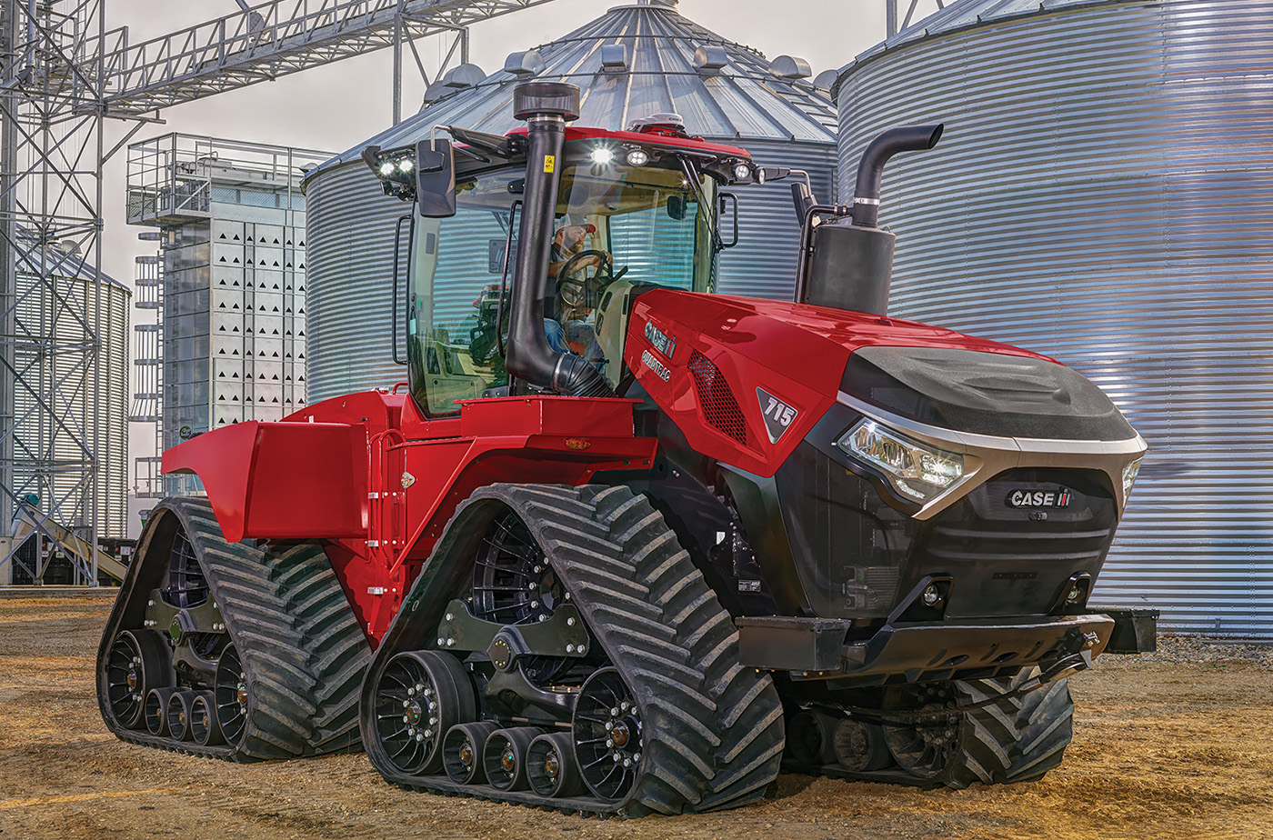 Large red agricultural vehicle with Trackman positive drive rubber tracks