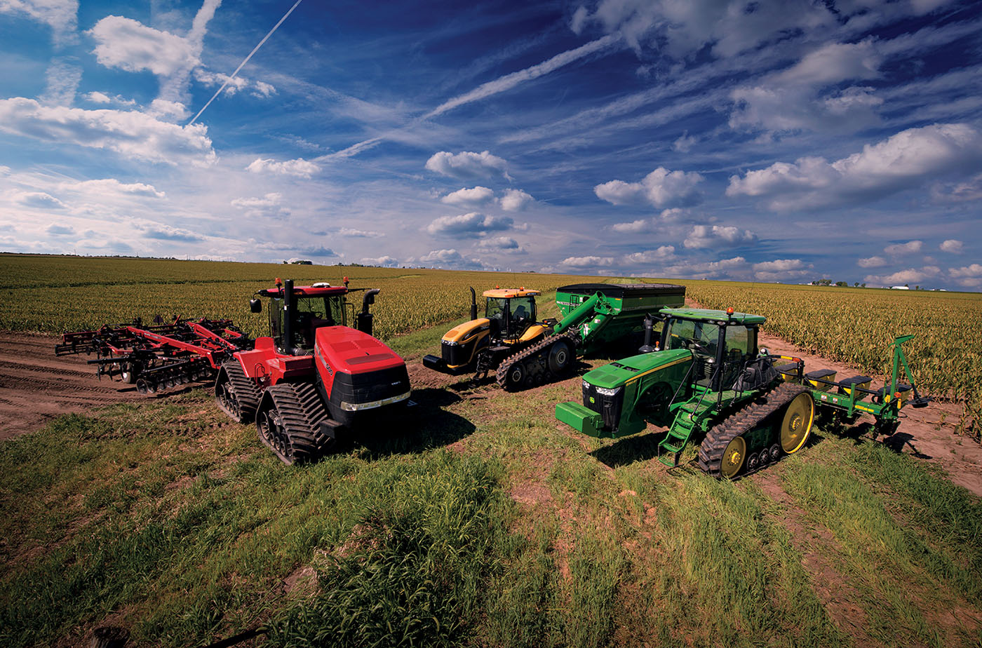 Group of tracked agricultural vehicles in field