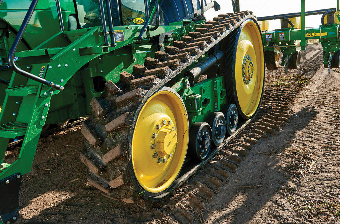 Friction drive rubber tracks on agricultural vehicle